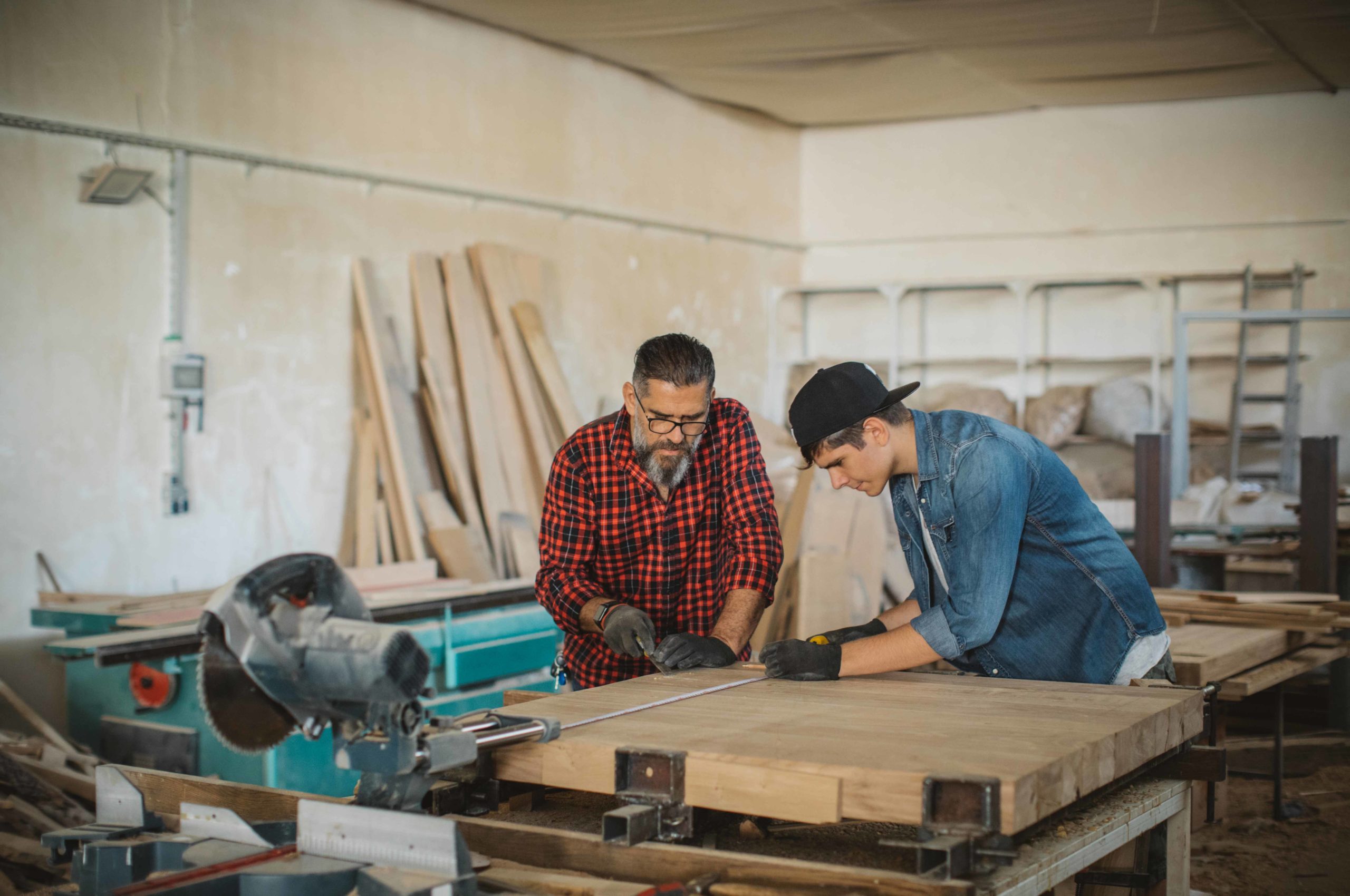 Father and son work together in a wood shop.